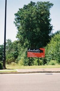 Vacant lot in Atlanta featuring a development opportunity sign amidst greenery.